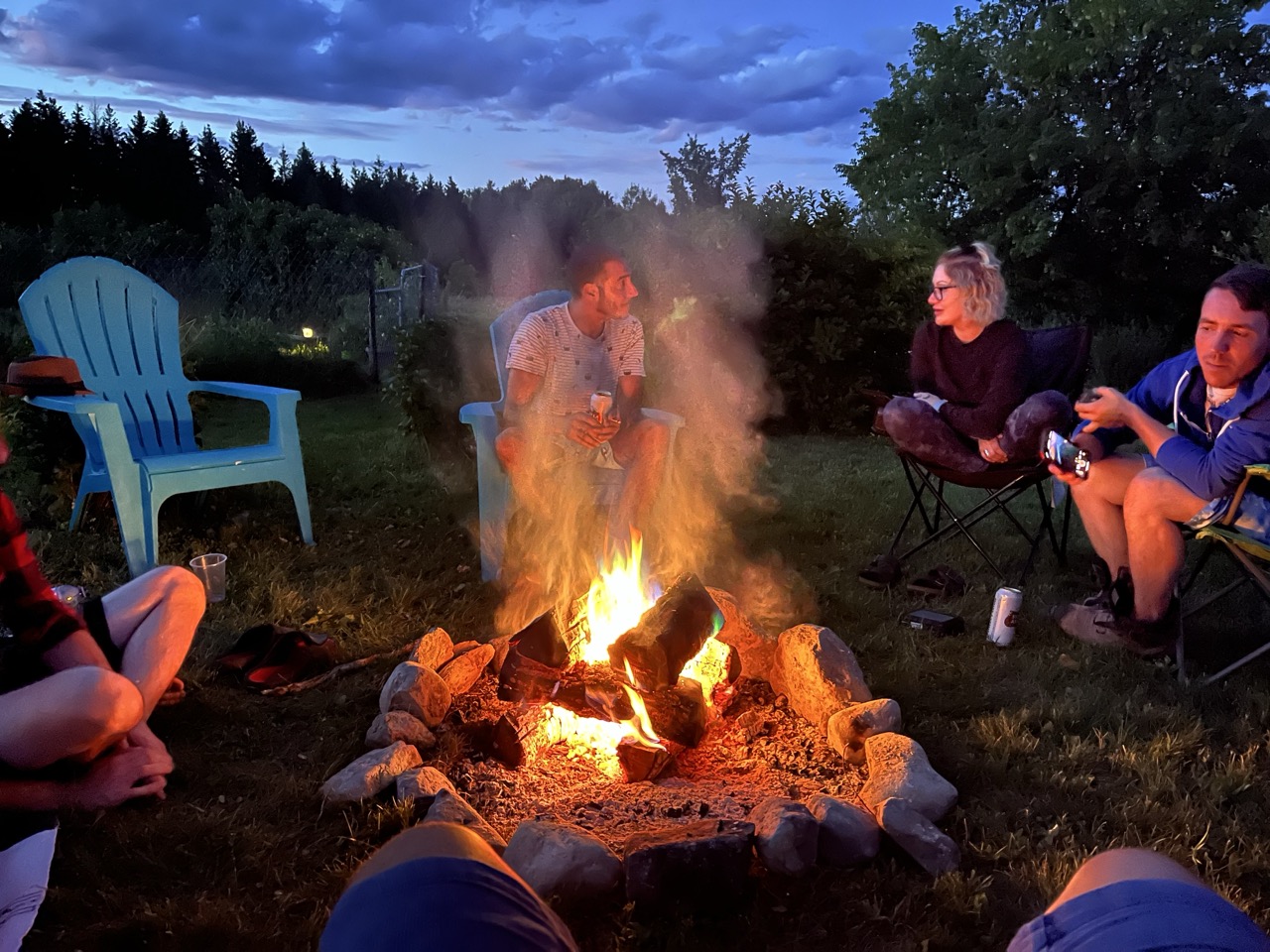 Course participants around the campfire at dusk